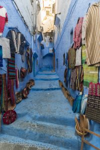 craft-products-arranged-on-wall-and-steps-for-sale-in-old-town-chefchaouen-morocco-TAMF02675