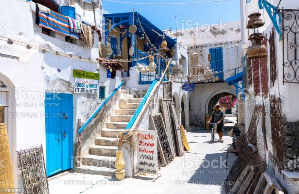 Tunisie. (Tunisie du Sud). Ile de Djerba. Houmt Souk. July 01, 2019. Man walking in a old street of the Medina